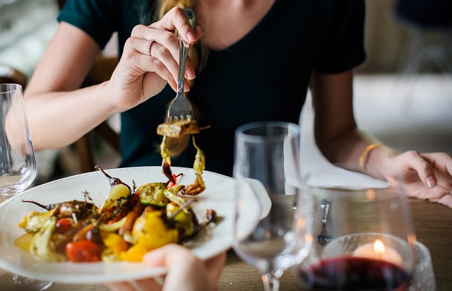 Photo of couple eating dinner with wine